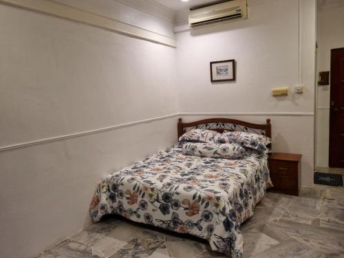 a bedroom with a bed with a comforter on it at D'Imar Homestay - Homestay Serendah in Serendah