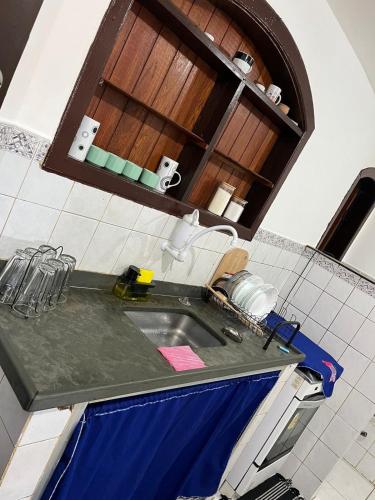 a kitchen with a sink and a counter top at Flat na beira da praia in Maricá