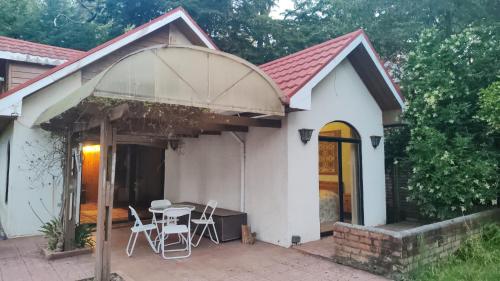 a small white house with a table and chairs at Casa encantadora con servicio de transporte al Aeropuerto in Osorno