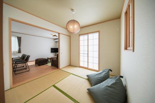 a living room with a couch and a window at Inamine K in Nago