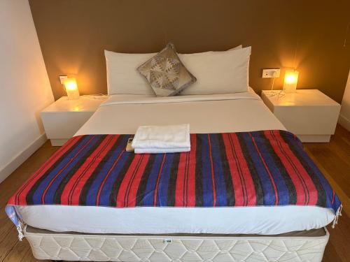 a large bed in a room with two lamps at KLCC Sky Villa Suites Platinum in Kuala Lumpur