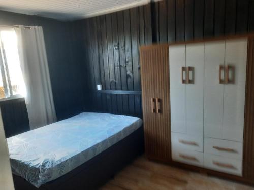a bedroom with a bed and a dresser at Servidão 1619 in Palhoça