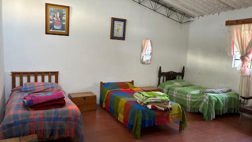 a room with two beds in a room at CorpoAgro HJC in Sonsón