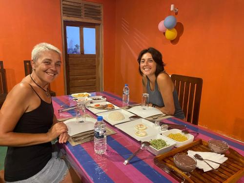 a man and a woman sitting at a table with food at Black Panther Yala in Tissamaharama