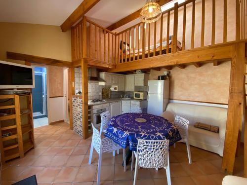 une cuisine avec une table et des chaises dans une pièce dans l'établissement Charmante maisonnette, proche mer, équipée, 3 chambres, terrasse - FR-1-709-49, à Fouras