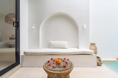 a bedroom with a bed and a table with flowers on it at Villa Tropical Nomad at Canggu in Badung