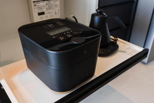 a black electronic device sitting on a table at ヴィラ Cy MOTOBU 沖縄本部町 一棟貸し in Motobu