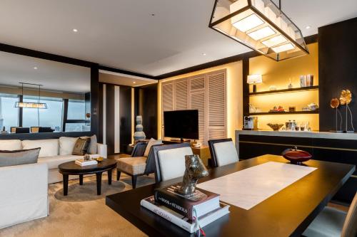 a living room with a couch and a table at Rosewood Phnom Penh in Phnom Penh
