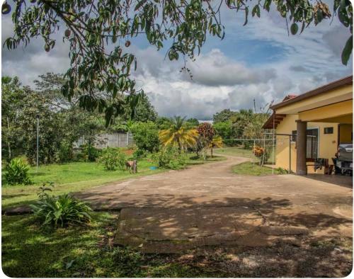 a driveway to a house with a yard at Modern Loft inside a beautiful farm in General Viejo