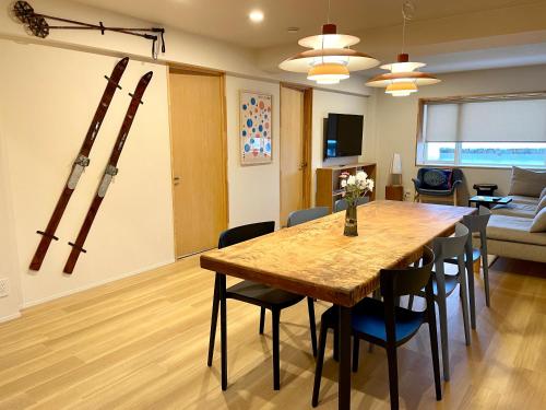 a dining room with a table and chairs at Den Nozawa in Nozawa Onsen