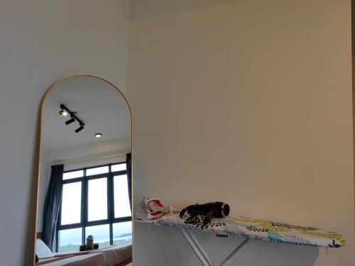 a dog sitting on a shelf in front of a mirror at Near Airport K Avenue Family Room in Donggongon