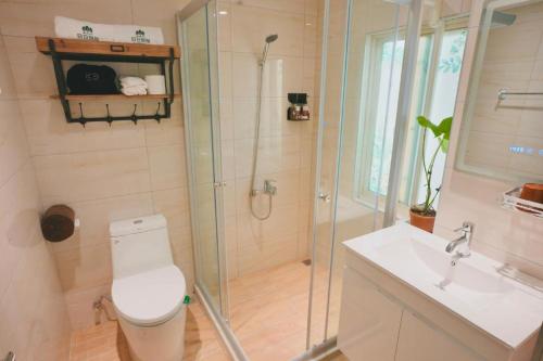 a bathroom with a shower and a toilet and a sink at 日日旅樹 Green Stay in Hualien City