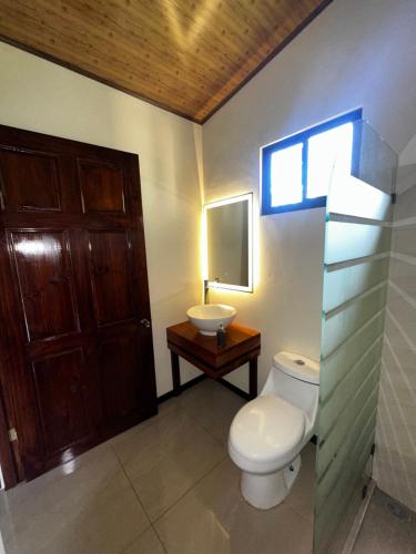 a bathroom with a toilet and a sink at Modern Loft inside a beautiful farm in General Viejo
