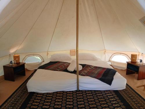 a bedroom with two beds in a tent at Naga Lodge in Luang Prabang