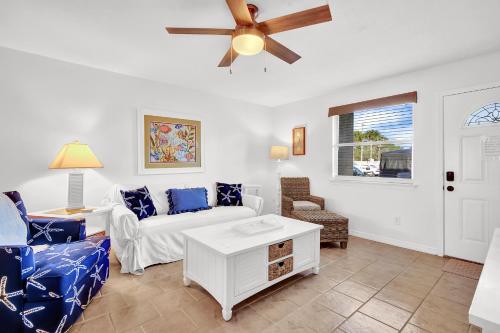 a living room with a couch and a ceiling fan at Sandcastles and Sunshine - Gulf Highlands Beach Resort in Panama City Beach