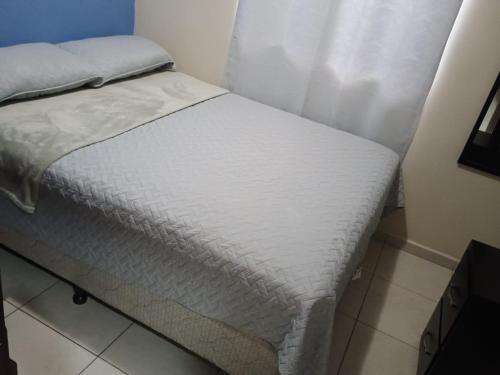 a bed in a small room with a white mattress at Tu casa fuera de casa in San Pedro Sula
