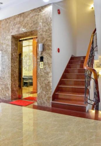 a lobby with a staircase and a glass door at Gia Nguyen Hotel Vung Tau in Vung Tau