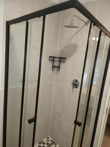 a shower with a glass door in a bathroom at Limewood 2 in Sandton