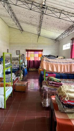 a room with a bunch of beds in it at CorpoAgro HJC in Sonsón