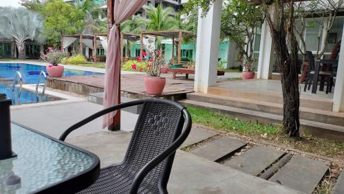 a table and a chair next to a pool at Twin Palms Resort in Sihanoukville