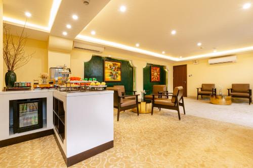 a lobby with a bar and chairs and tables at Hoi An Memories Resort & Spa in Hoi An