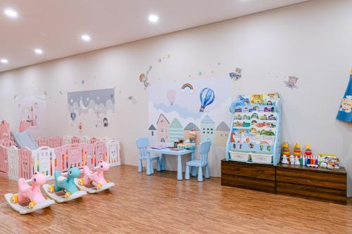 a childrens room with pink and blue childrens furniture at Hoi An Memories Resort & Spa in Hoi An