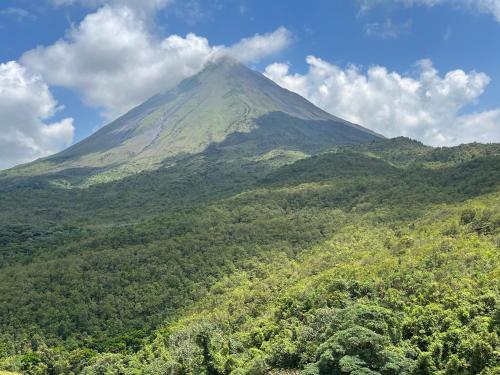 a mountain in the middle of a forest at Las Flores Charming Home, near La Fortuna in Guayabal