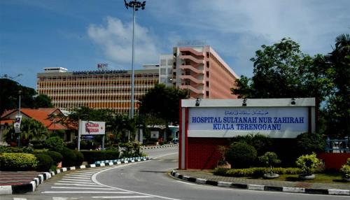 a road with a sign in front of a building at TY Hotel in Kuala Terengganu