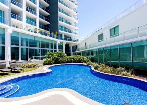 a swimming pool in front of a building at Elegant Splendor 3 bedroom Apartment with Tram Access in Gold Coast