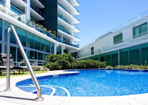 a swimming pool in front of a building at Elegant Splendor 3 bedroom Apartment with Tram Access in Gold Coast