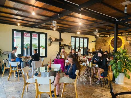 a group of people sitting at tables in a restaurant at The Muse House in Hoi An