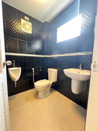 a bathroom with a toilet and a sink at Ban MeeDee in Chiang Mai