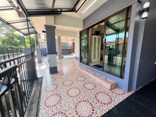 a house with a red and white tile floor at Ban MeeDee in Chiang Mai