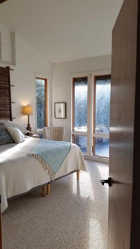 a bedroom with a bed and a large window at Amazing Getaway Oceanview with treehouse feel in Manchester