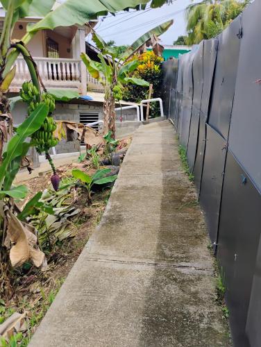 a walkway in front of a house with a fence at Country Vibe 2 bedroom apartment in Vieux Fort