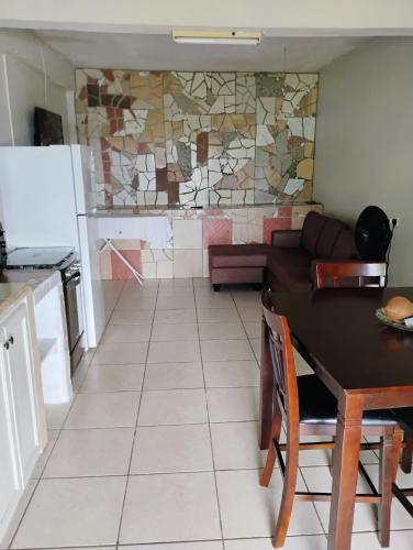 a kitchen and a dining room with a table and a kitchen and a kitchen at Country Vibe 2 bedroom apartment in Vieux Fort