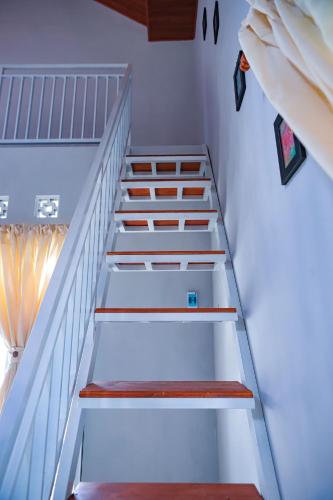 a set of stairs in a stair case at Mahogany Garden Villa Jogja in Ngingas
