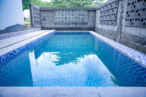 a swimming pool with blue water in a backyard at Mahogany Garden Villa Jogja in Ngingas