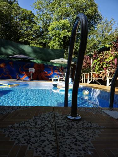 a pool at a resort with a water slide at Cool Waters Jungle Villas in Uvita