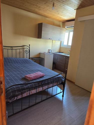 a bed in a small room with a kitchen at City Center Holiday room in Limassol