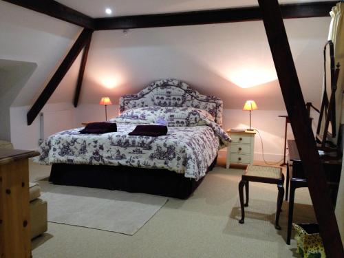 a bedroom with a bed and a dresser with two lamps at Prince Hill House in Devizes