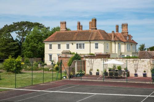 a large house with a tennis court in front of it at Prince Hill House in Devizes
