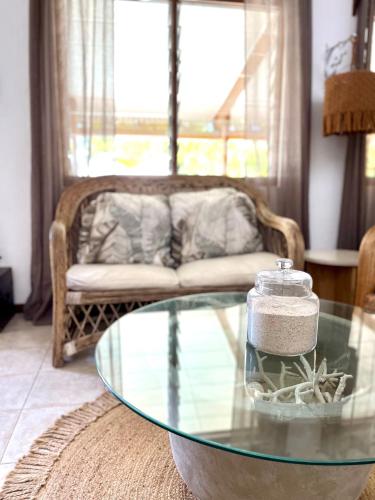 a living room with a glass table and a couch at Patraka - 'No worries' in Rivière Noire