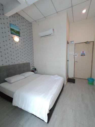 a bedroom with a large white bed in a room at Hotel Bestari in Melaka