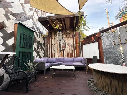 a patio with a purple couch and a table at The Rosemary in Los Angeles