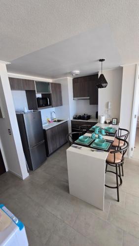 a kitchen with a table and chairs in a room at Home life 28 in Iquique