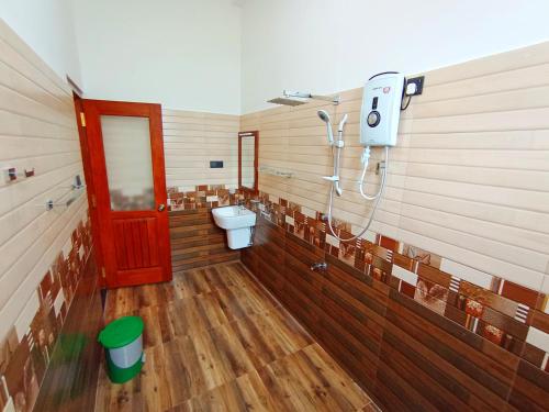 a bathroom with a toilet and a red door at Luxury Peak Villa in Mirissa