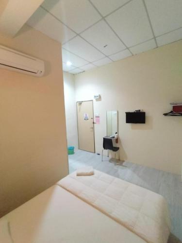 a hospital room with a bed and a mirror at Hotel Bestari in Melaka