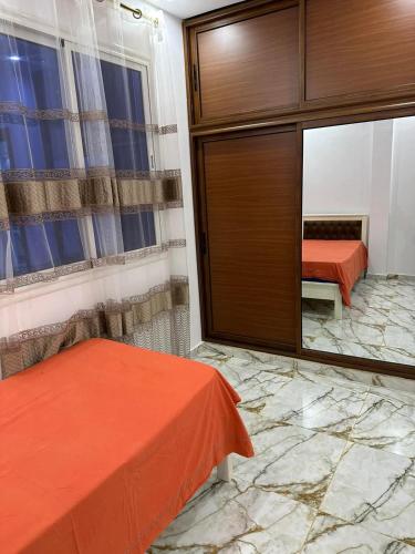 Ένα ή περισσότερα κρεβάτια σε δωμάτιο στο Mahdia vacances