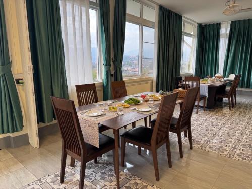 a dining room with a table and chairs at Garden House Rice Field and Mountain View in Luang Prabang